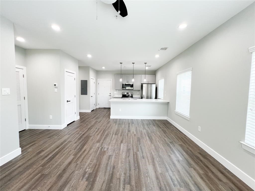144 West 5th Street, Unit B Kemah, TX 77565 - Photo 8 of 22 a view of a kitchen with a dishwasher and cabinets