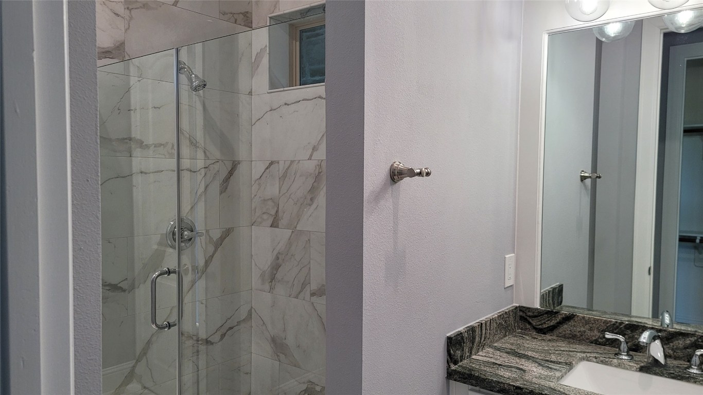 9729 Neuens Road Houston, TX 77080 - Photo 21 of 34 a bathroom with a sink and a mirror
