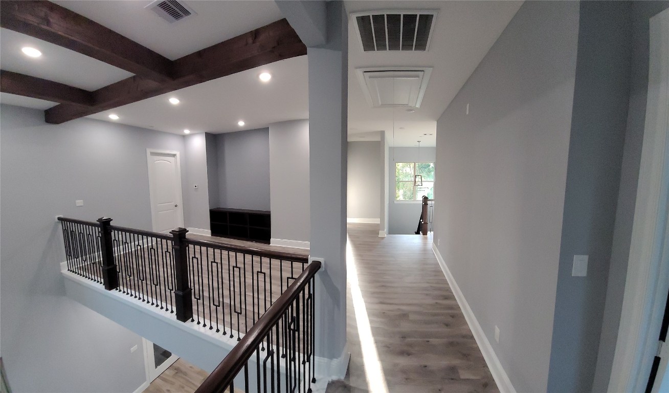 9729 Neuens Road Houston, TX 77080 - Photo 32 of 34 a view of a hallway with wooden floor and windows