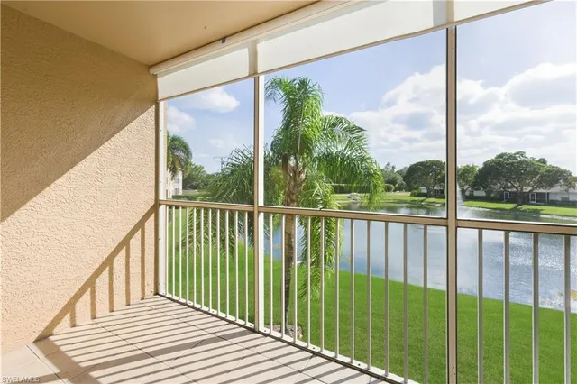 a view of a balcony with yard