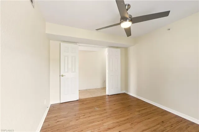 a view of an empty room with wooden floor