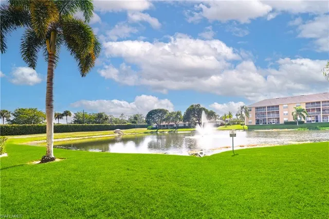 a view of a lake with houses in the back