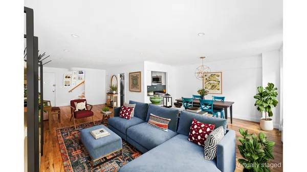 a living room with furniture and flowers