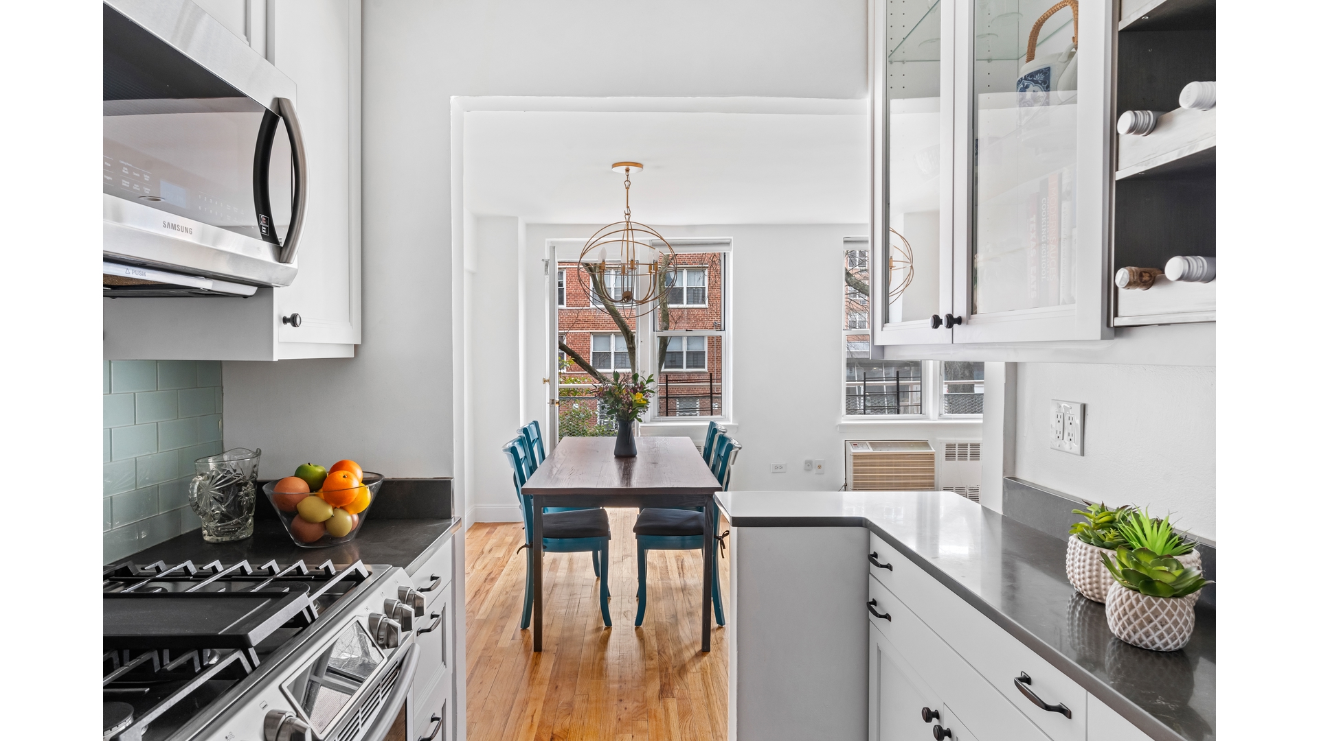 415 Argyle Road, Unit 2/3L Brooklyn, NY 11218 - Photo 9 of 23 a kitchen with stainless steel appliances kitchen island granite countertop a stove a sink and a microwave