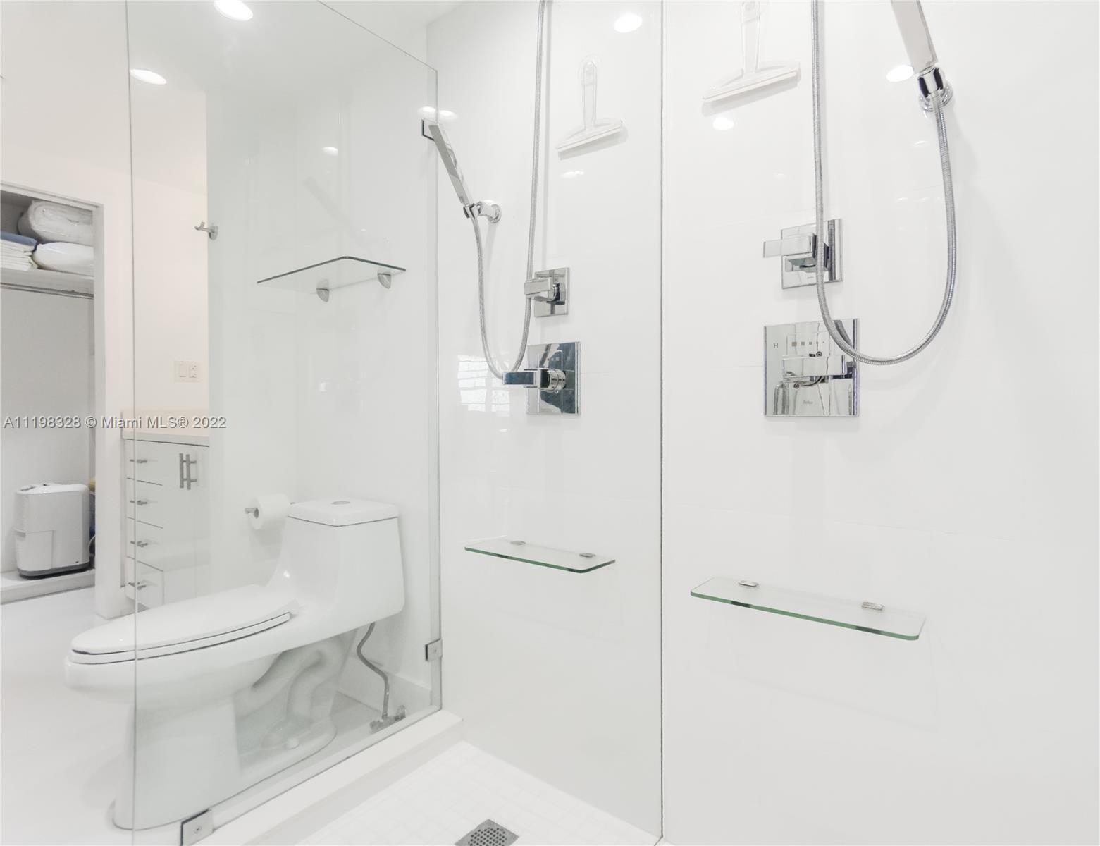 100 Lincoln Road, Unit 646 Miami Beach, FL 33139 - Photo 16 of 21 a bathroom with a granite countertop sink mirror vanity and toilet