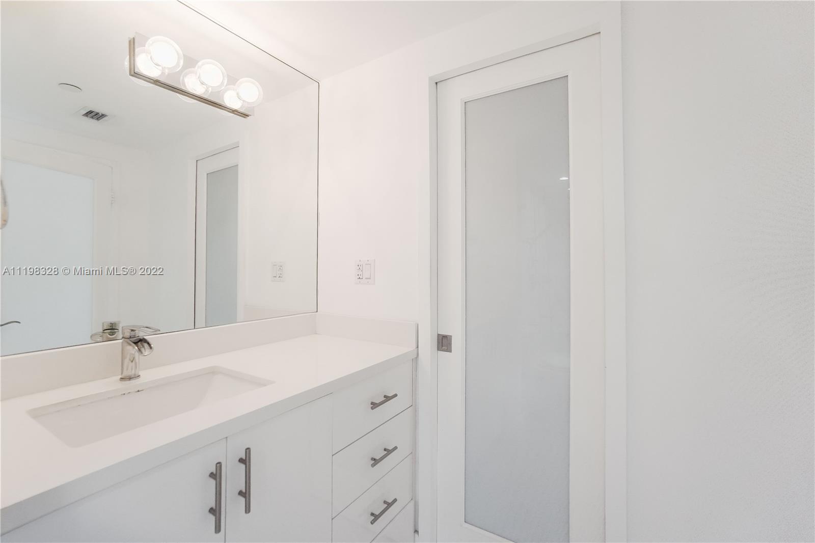 100 Lincoln Road, Unit 646 Miami Beach, FL 33139 - Photo 17 of 21 a bathroom with a sink and a mirror