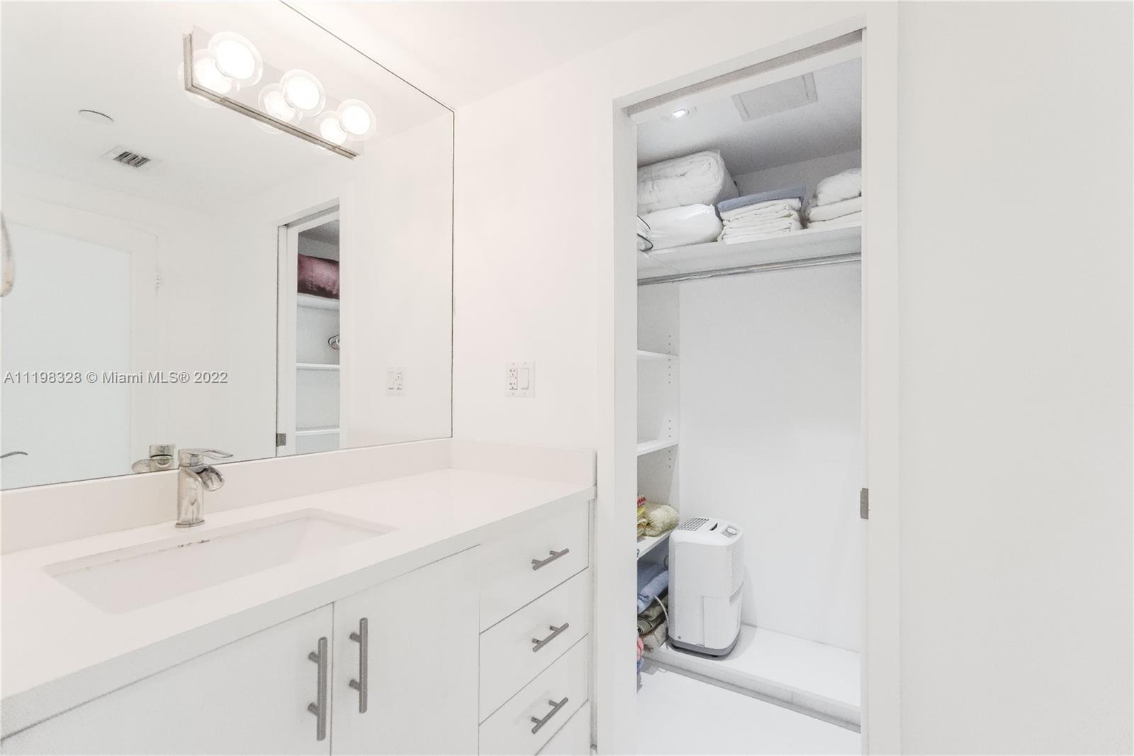 100 Lincoln Road, Unit 646 Miami Beach, FL 33139 - Photo 18 of 21 a bathroom with a sink and mirror