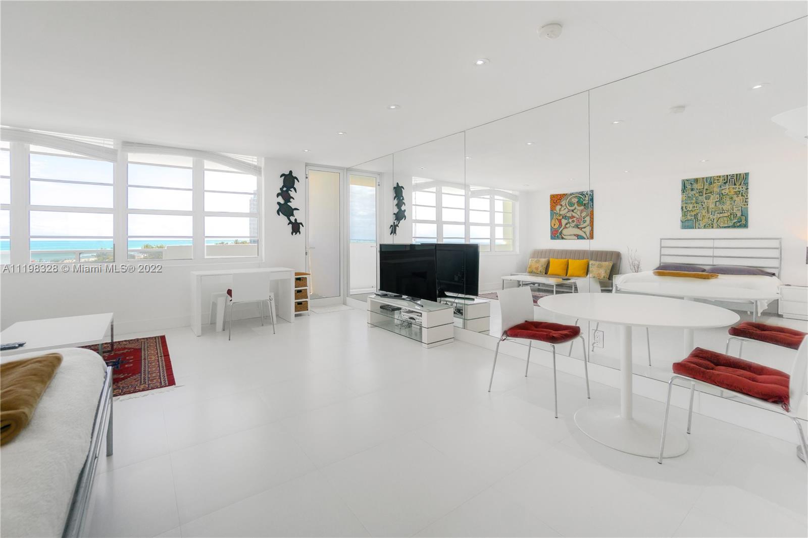 100 Lincoln Road, Unit 646 Miami Beach, FL 33139 - Photo 6 of 21 a living room with furniture and a flat screen tv