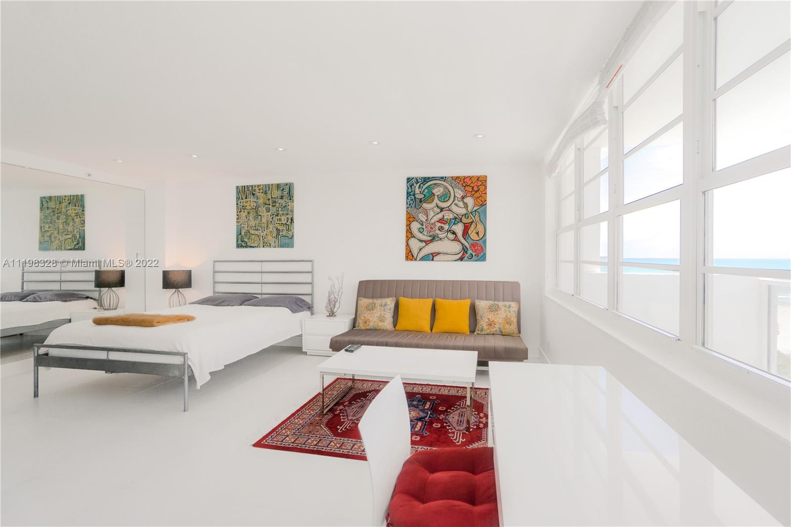 100 Lincoln Road, Unit 646 Miami Beach, FL 33139 - Photo 7 of 21 a living room with furniture and a large window