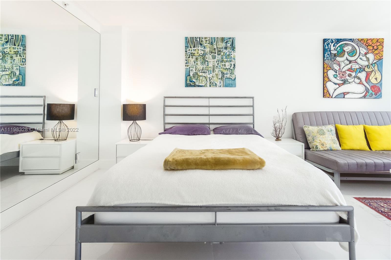 100 Lincoln Road, Unit 646 Miami Beach, FL 33139 - Photo 9 of 21 a bedroom with a bed and window