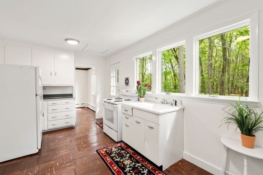 32 Whitman Road Harvard, MA 01451 - Photo 17 of 38 a kitchen with a stove a sink and a refrigerator