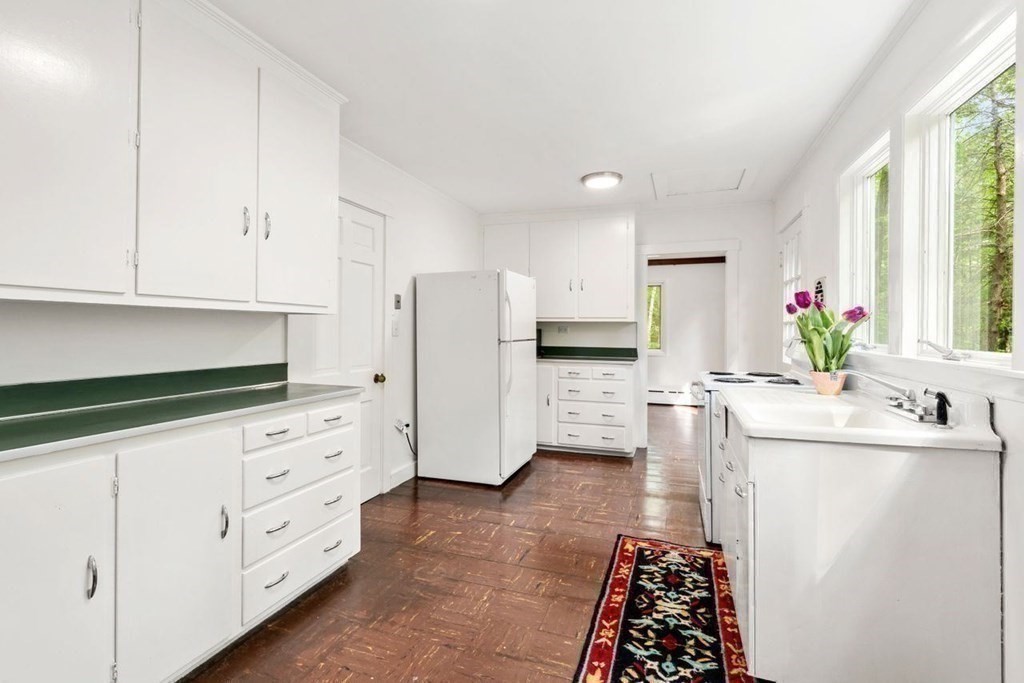 32 Whitman Road Harvard, MA 01451 - Photo 18 of 38 a kitchen with white cabinets and window
