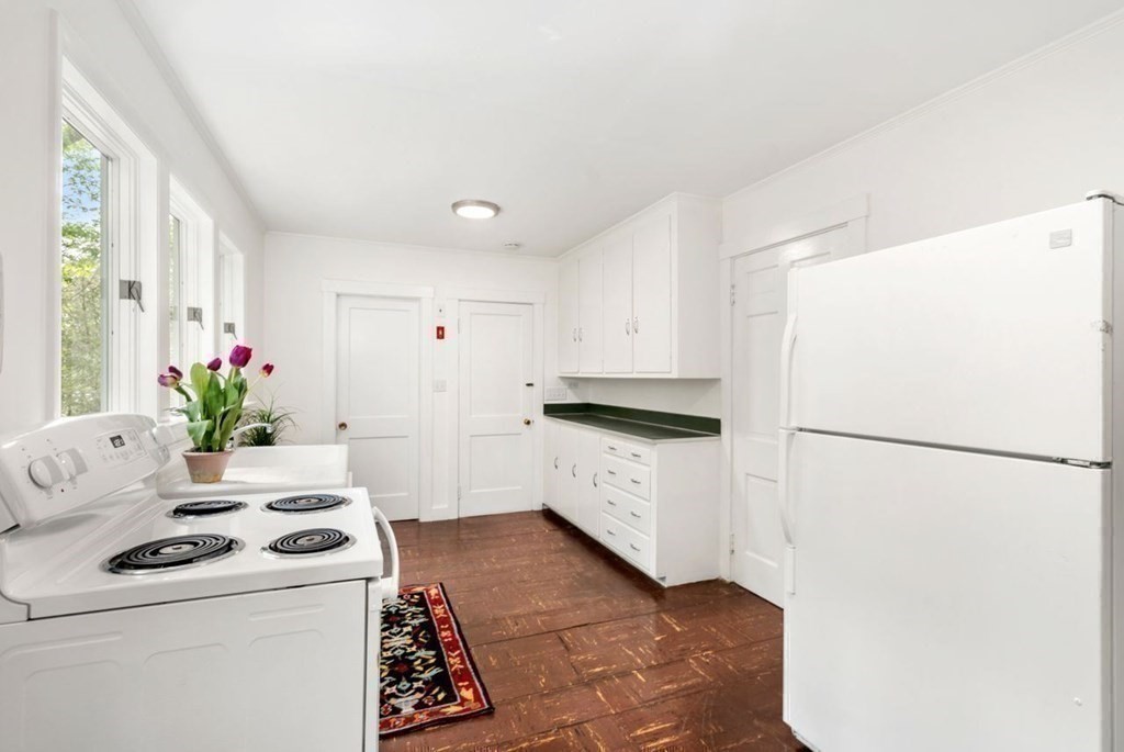 32 Whitman Road Harvard, MA 01451 - Photo 19 of 38 a kitchen with a refrigerator sink and white cabinets