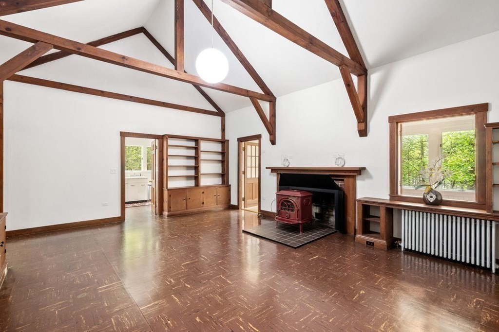 32 Whitman Road Harvard, MA 01451 - Photo 10 of 38 a view of an empty room with wooden floor fireplace and a window