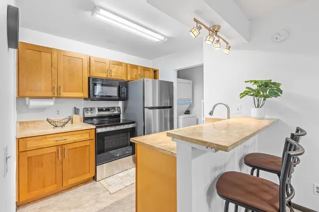 a kitchen with a table chairs refrigerator and microwave