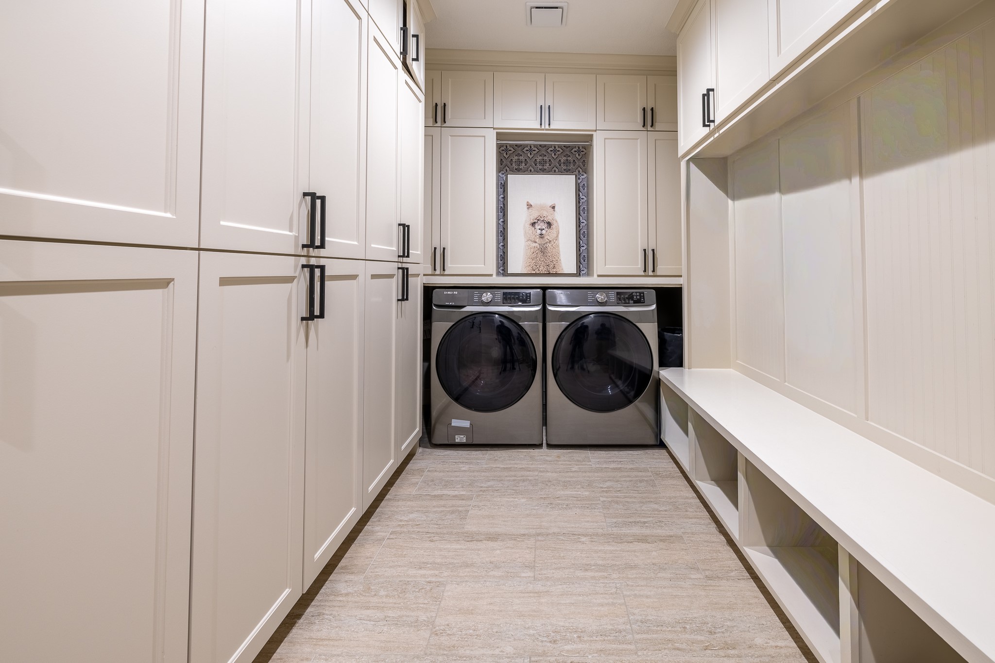 5230 Redstart Street Houston, TX 77035 - Photo 17 of 30 Dedicated laundry room with side-by-side washer and dryer and custom cabinetry
