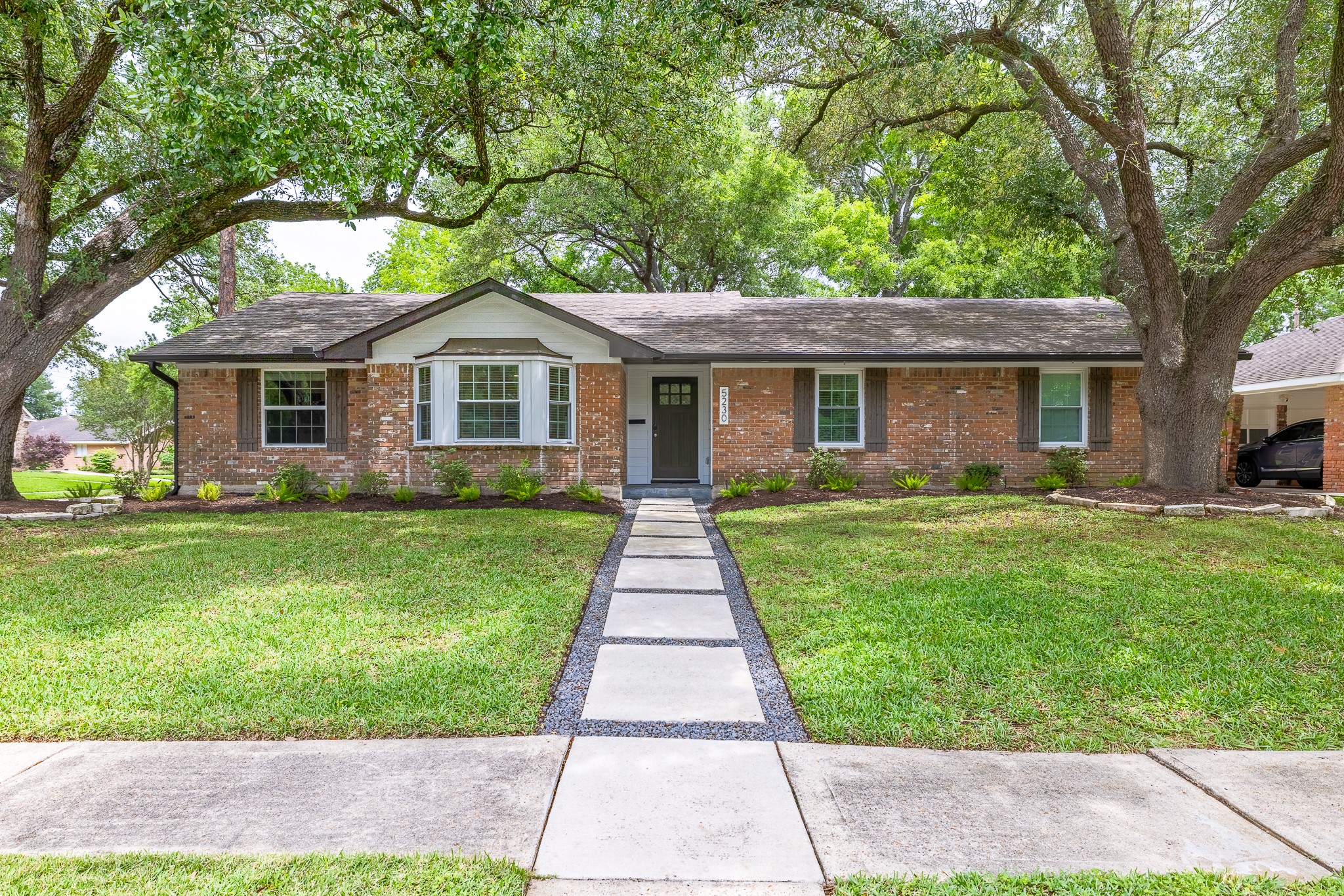 5230 Redstart Street Houston, TX 77035 - Photo 2 of 30 Classic Westbury exterior framed by mature trees — completely rebuilt from the slab up in 2021