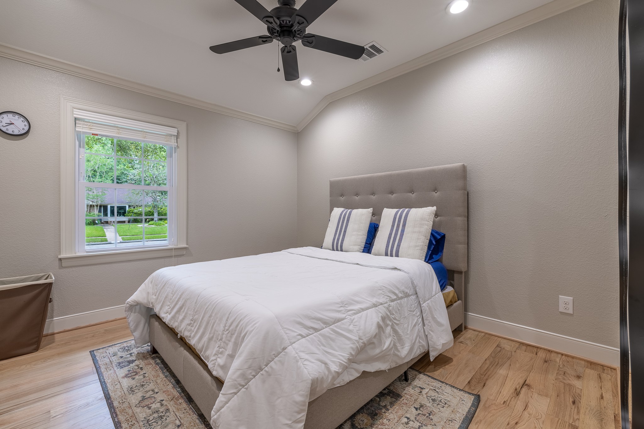 5230 Redstart Street Houston, TX 77035 - Photo 23 of 30 Generously sized secondary bedroom with hardwood floors and ceiling fan