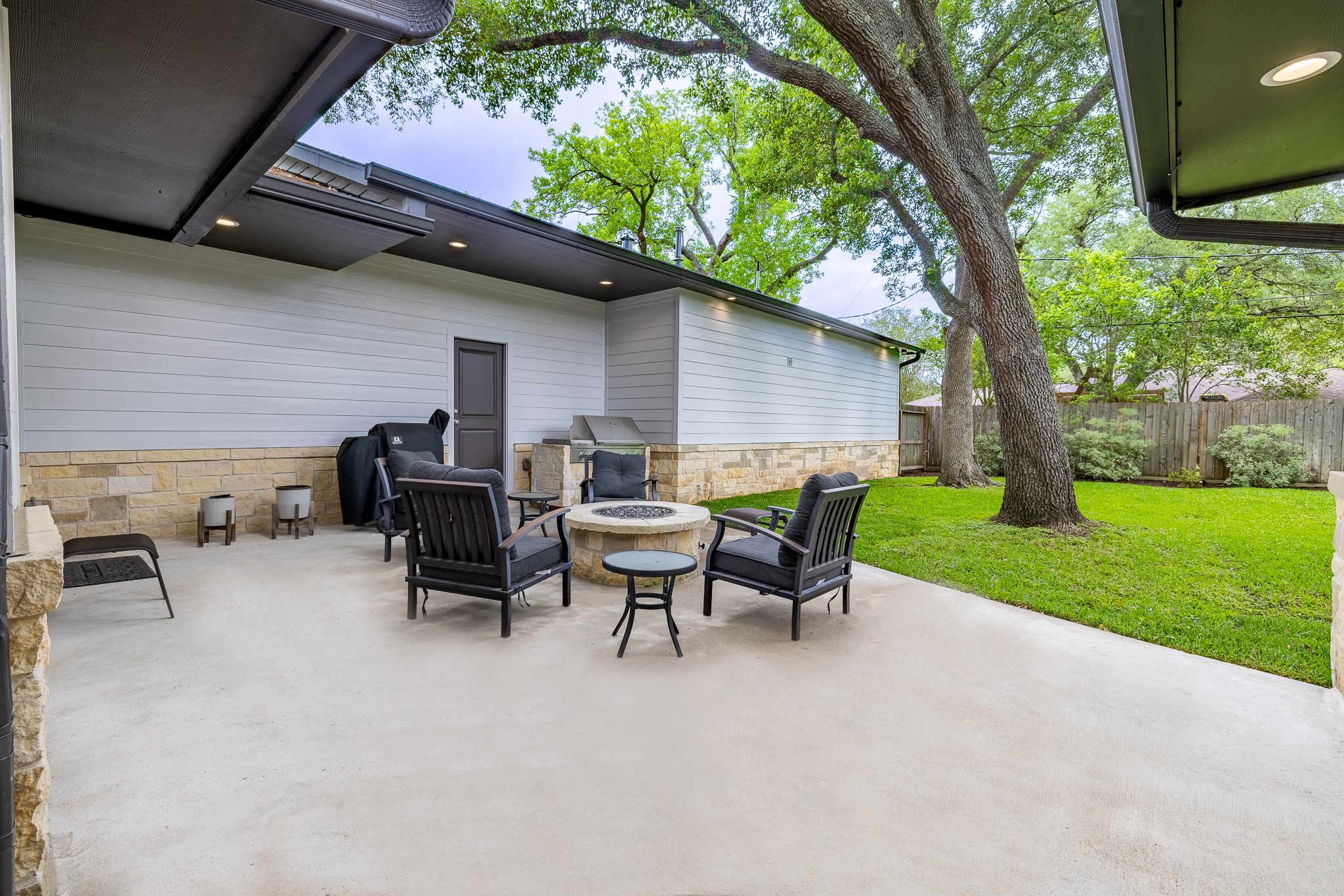 5230 Redstart Street Houston, TX 77035 - Photo 26 of 30 Outdoor entertaining area featuring a gas fire pit and built-in gas grill — perfect for Houston evenings year-round