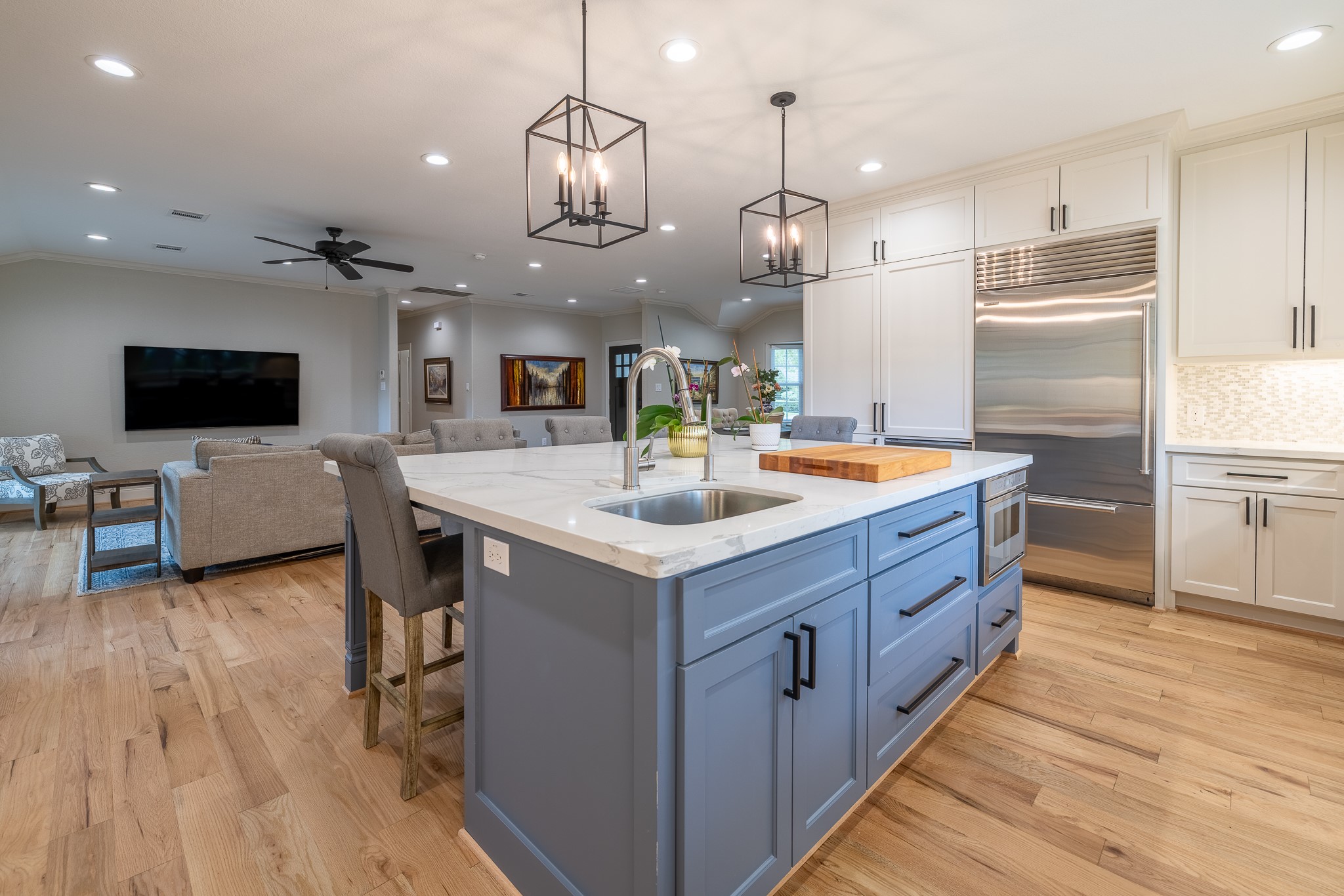 5230 Redstart Street Houston, TX 77035 - Photo 5 of 30 Chef's kitchen featuring designer pendant lighting, large island with seating, and premium finishes throughout