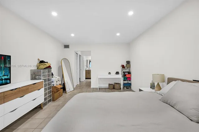 a bed room with a bed and a dresser