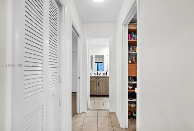 a bathroom with a double vanity sink toilet mirror and shower