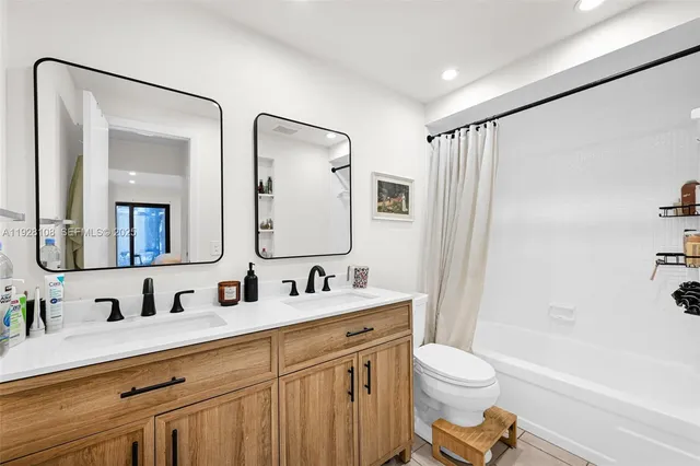 a bathroom with a sink vanity and a mirror
