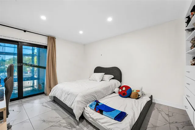 a bedroom with a large bed and a flat screen tv