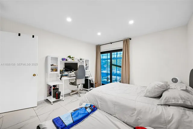 a bed room with a bed and a television