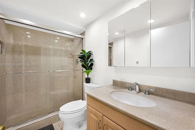 a bathroom with a toilet a sink and a mirror