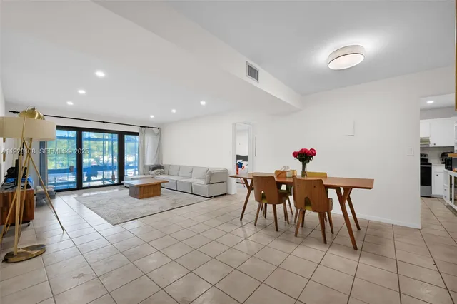 a view of a dining room with furniture and chandelier