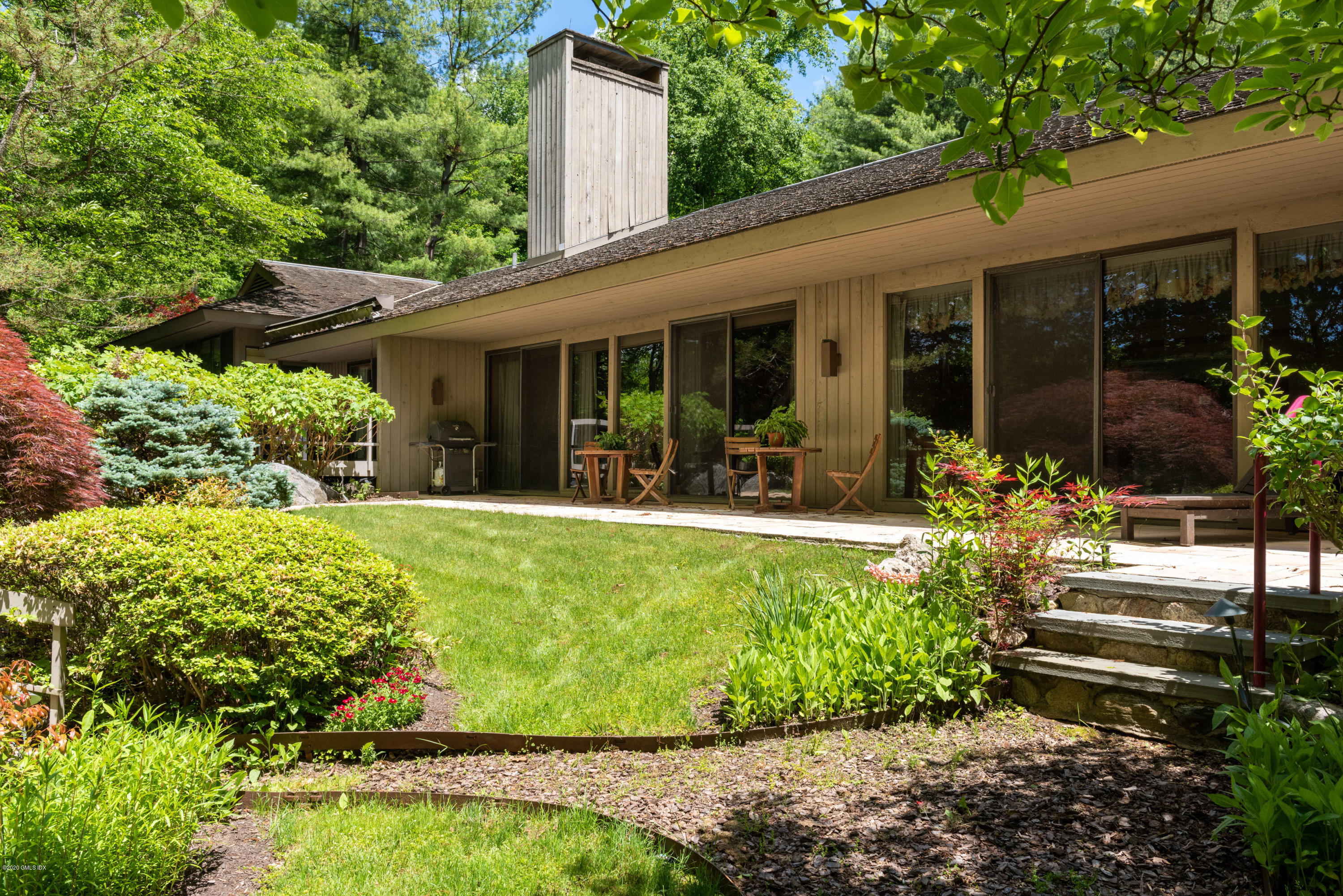 51-0 Burying Hill Road Greenwich, CT 06831 - Photo 23 of 47 a view of a house with backyard sitting area and garden