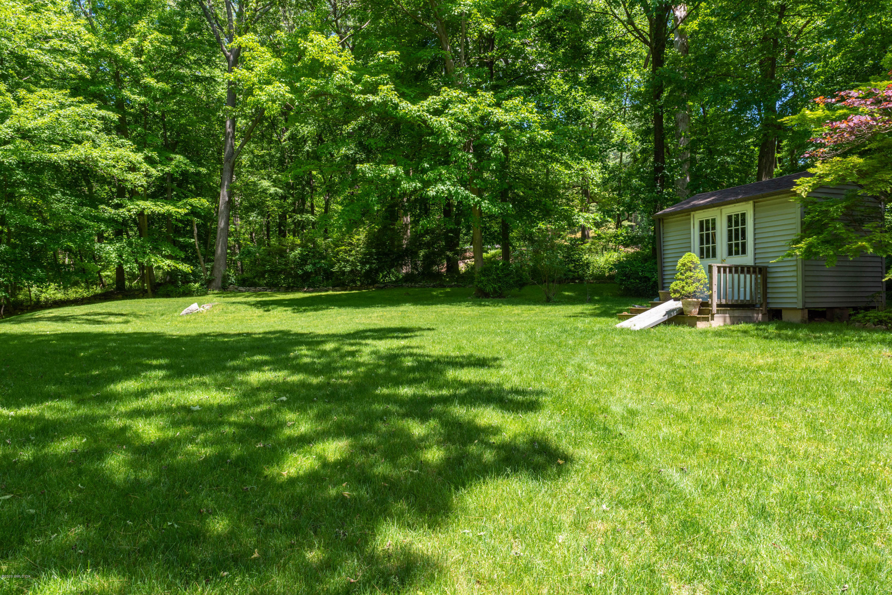 51-0 Burying Hill Road Greenwich, CT 06831 - Photo 26 of 47 a view of a backyard with large trees