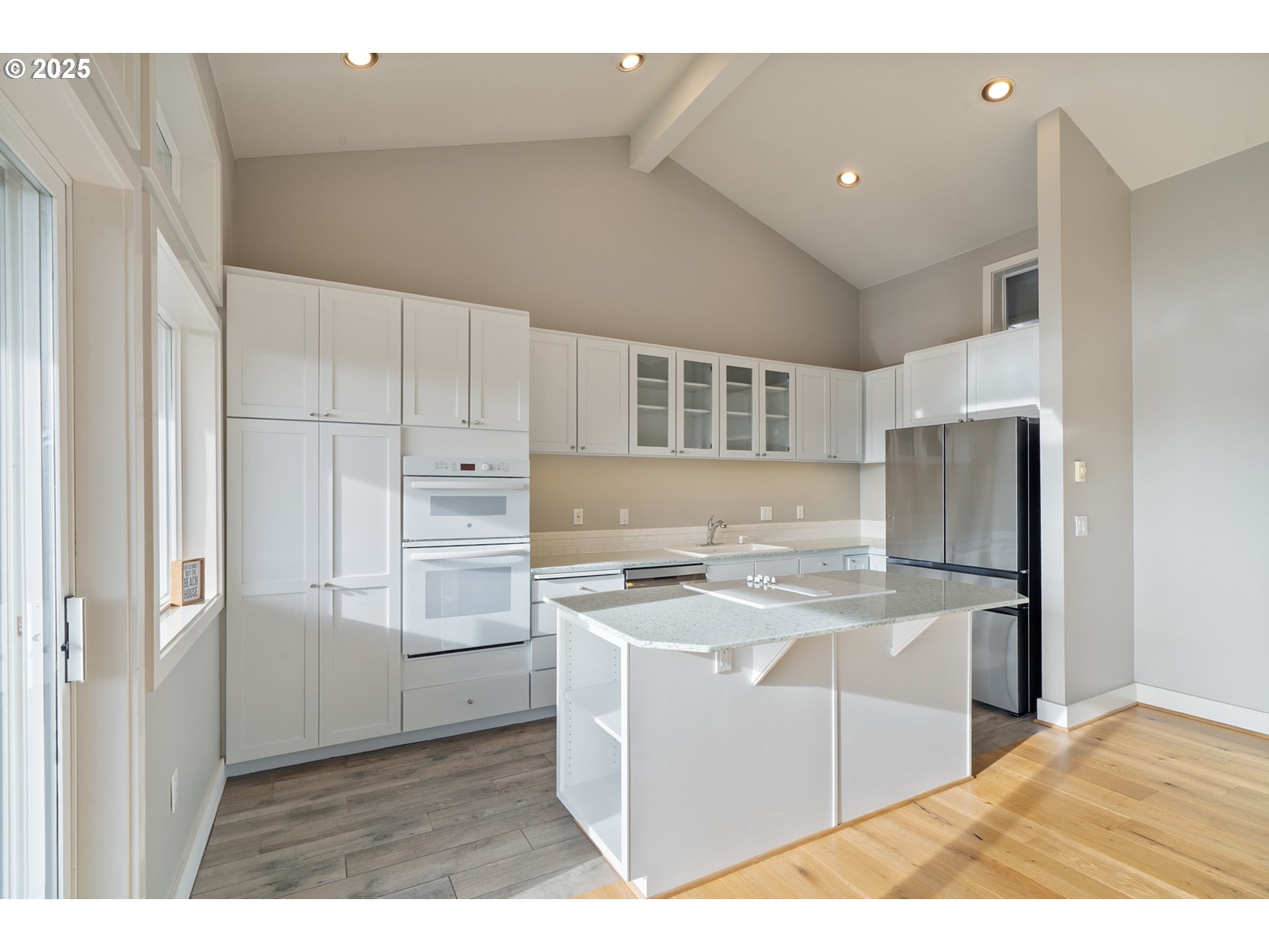 455 Capes Drive Oceanside, OR 97141 - Photo 11 of 48 a kitchen with stainless steel appliances granite countertop a refrigerator and a stove