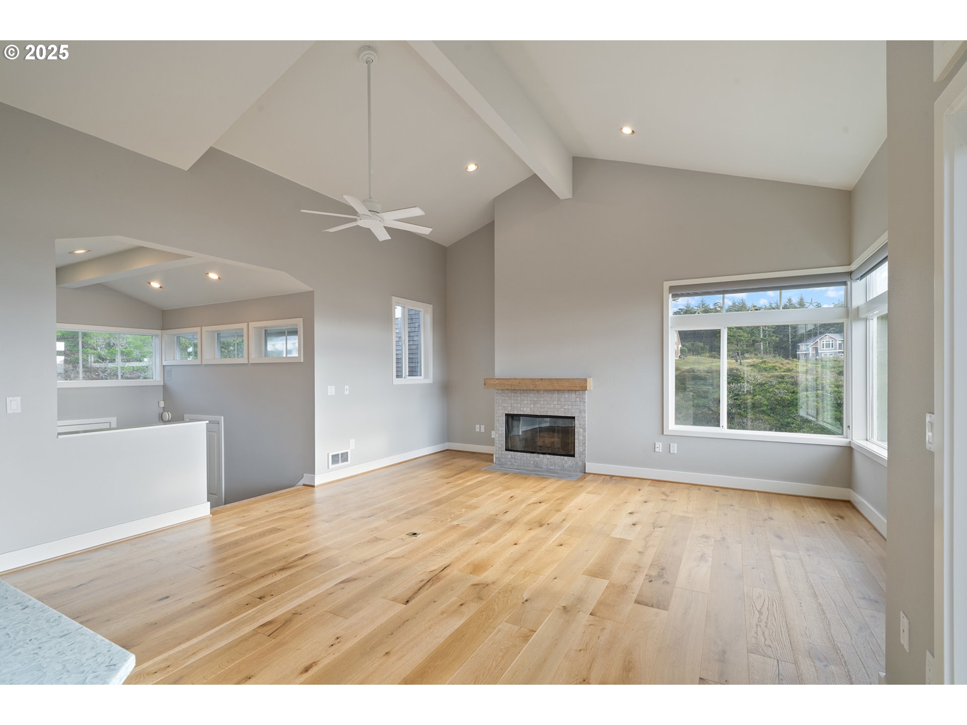 455 Capes Drive Oceanside, OR 97141 - Photo 13 of 48 a view of an empty room with a window and wooden floor