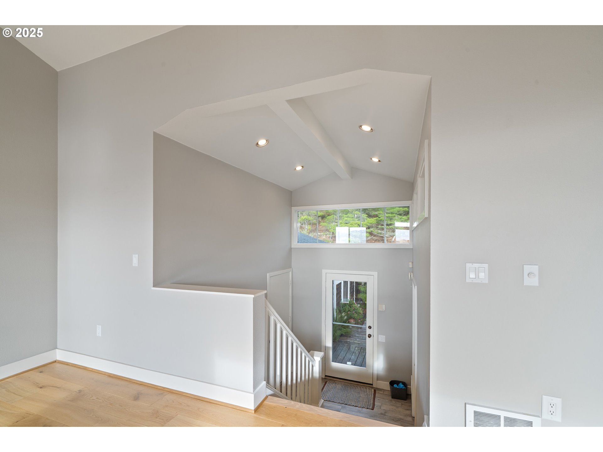 455 Capes Drive Oceanside, OR 97141 - Photo 16 of 48 a view of a hallway with wooden floor and windows