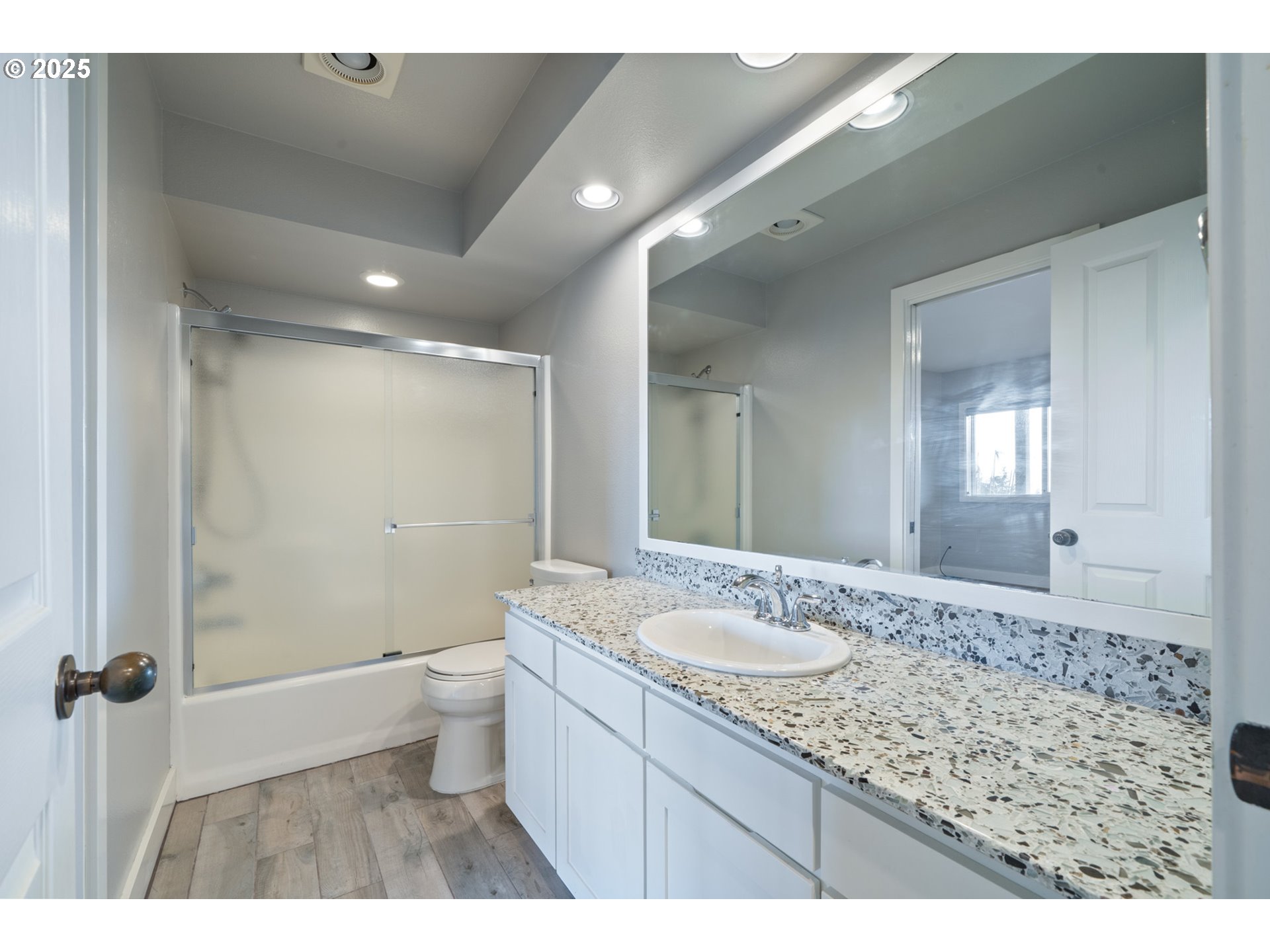 455 Capes Drive Oceanside, OR 97141 - Photo 32 of 48 a bathroom with a granite countertop sink a toilet a mirror and shower