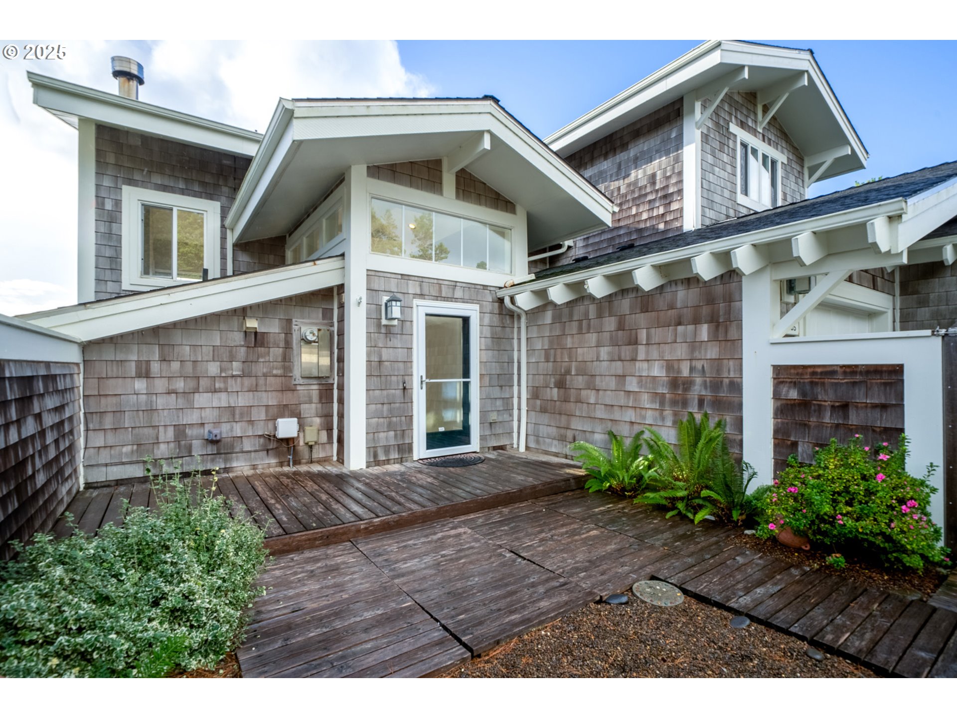 455 Capes Drive Oceanside, OR 97141 - Photo 40 of 48 a front view of a house with garden