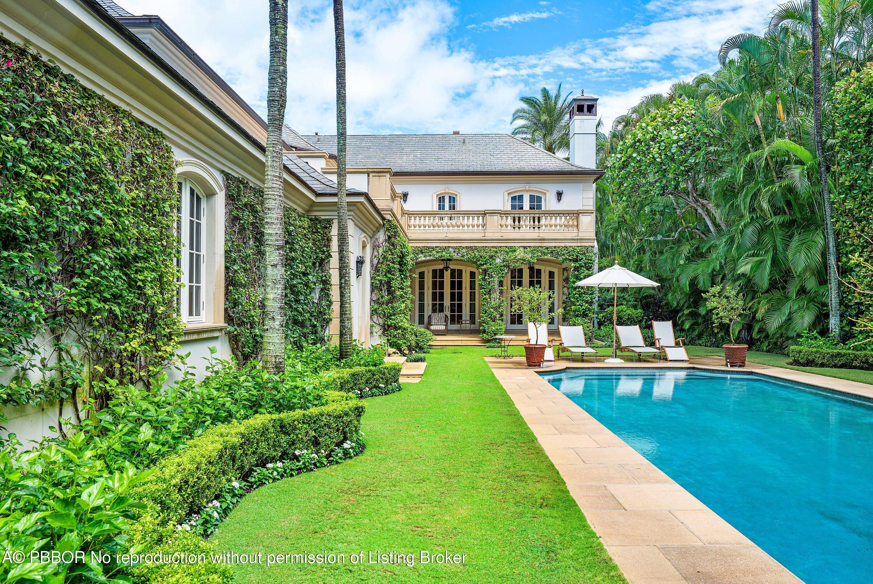 242 Wells Road Palm Beach, FL 33480 - Photo 32 of 54 a view of an house with swimming pool and sitting area