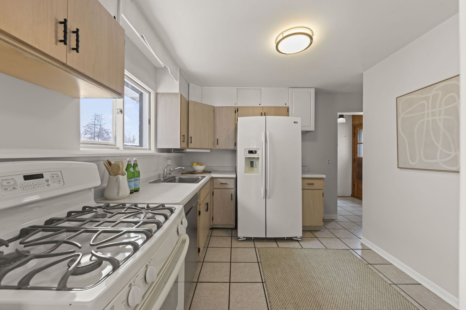 357 Bryant Avenue Glen Ellyn, IL 60137 - Photo 5 of 22 a kitchen with a refrigerator a stove and white cabinets