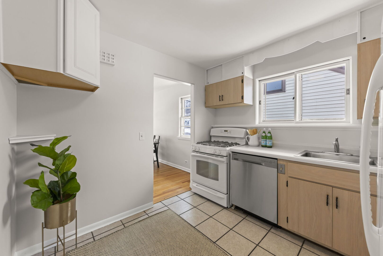 357 Bryant Avenue Glen Ellyn, IL 60137 - Photo 6 of 22 a kitchen with a sink cabinets and window