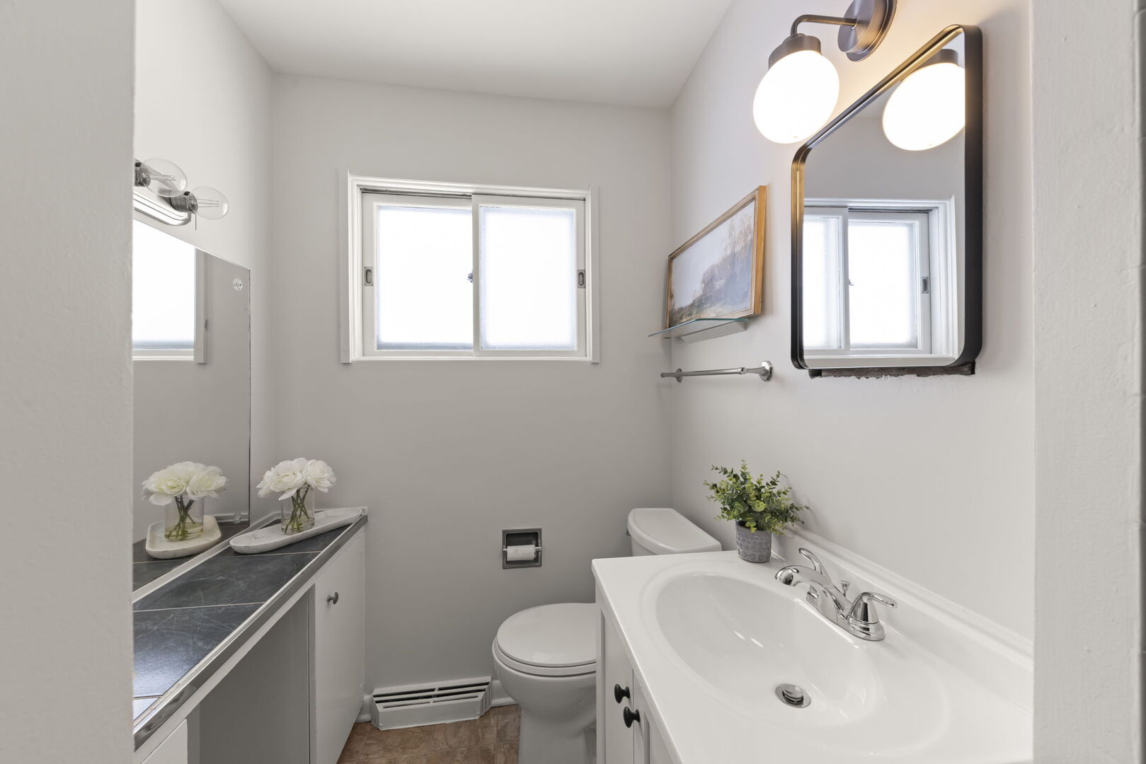 357 Bryant Avenue Glen Ellyn, IL 60137 - Photo 10 of 22 a bathroom with a sink a toilet and mirror