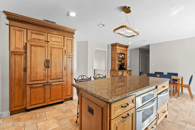 a kitchen with a table and refrigerator