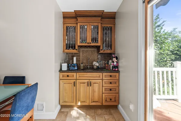 a kitchen with a cabinets and chandelier
