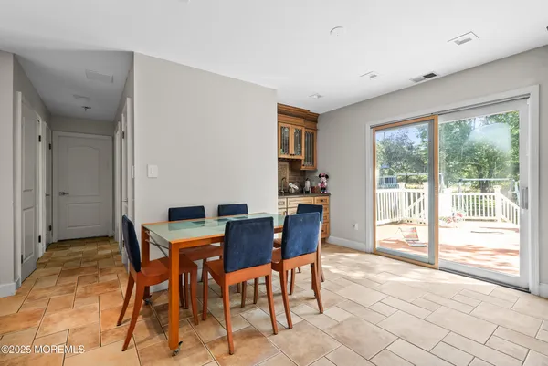 a view of a dining room with furniture large windows and wooden floor