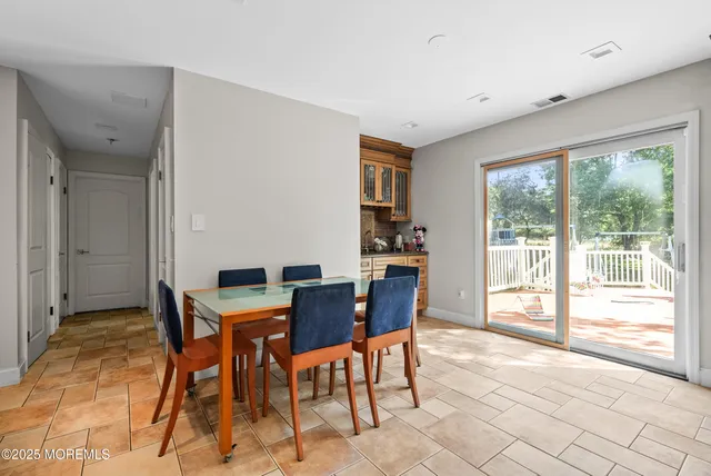 a view of a dining room with furniture large windows and wooden floor