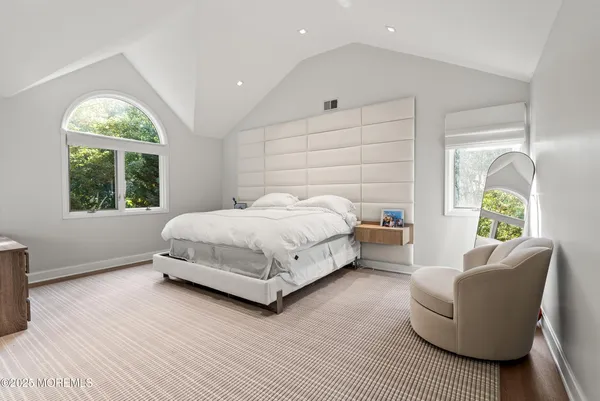 a bedroom with a bed couch and a window
