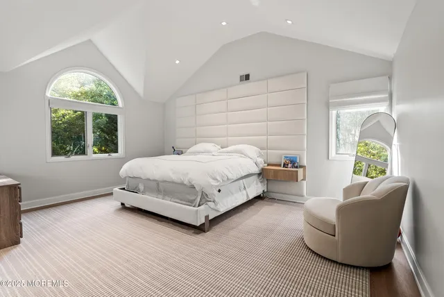 a bedroom with a bed couch and a window