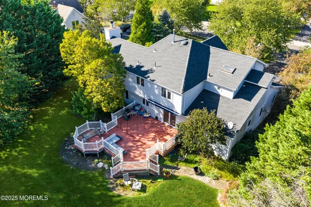 an aerial view of a house with garden space and street view