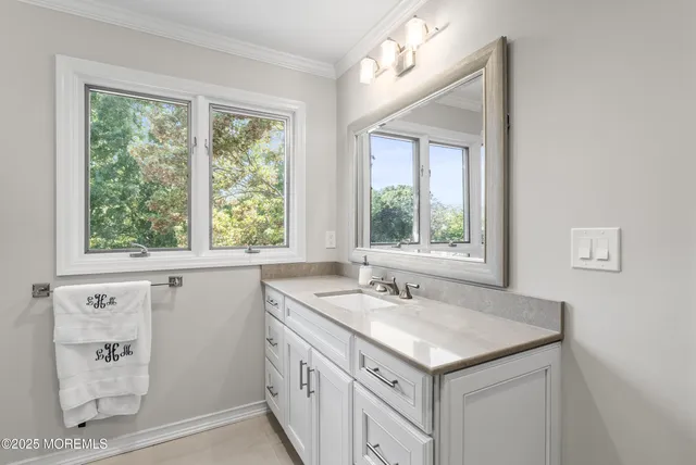 a bathroom with a sink and a window